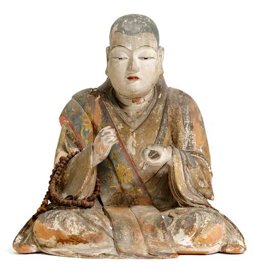 A SEATED FIGURE OF A MONK.