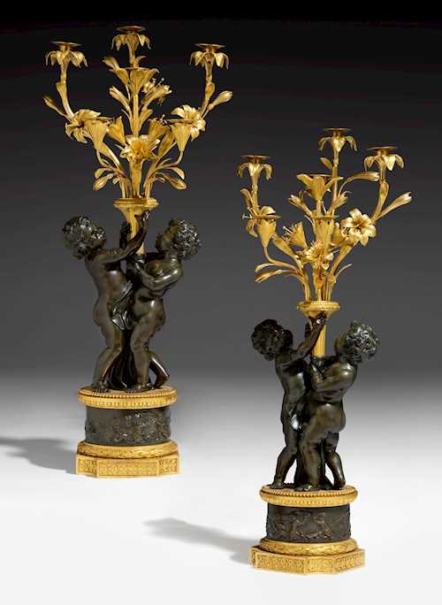 A PAIR OF CANDELABRA “CHILDREN WITH LILIES”