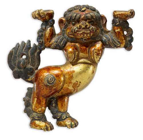 A CAST GILT COPPER ALLOY SNOW LION.