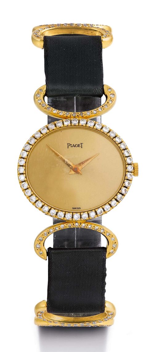 PIAGET DIAMOND LADY'S WRISTWATCH, 1970s. Yellow gold 750. Ref. 9806DB, transverse-oval case No. 290896, diamond lunette with ca. 40 diamonds, oval lugs set with diamonds. Gold dial with gold hands. Hand winding movement. Satin band with oval intermediate links set with diamonds. Original clasp set with diamonds. D 27 x 24 mm.